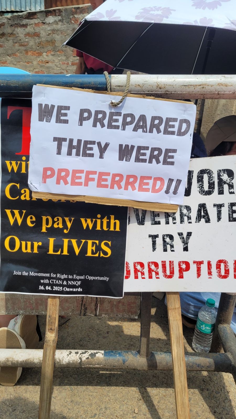 Banners voice out the recent absorption of 147 assistant professors and librarians during a rally outside the Directorate of Higher Education, Kohima, on April 21. (Morung Photo)
